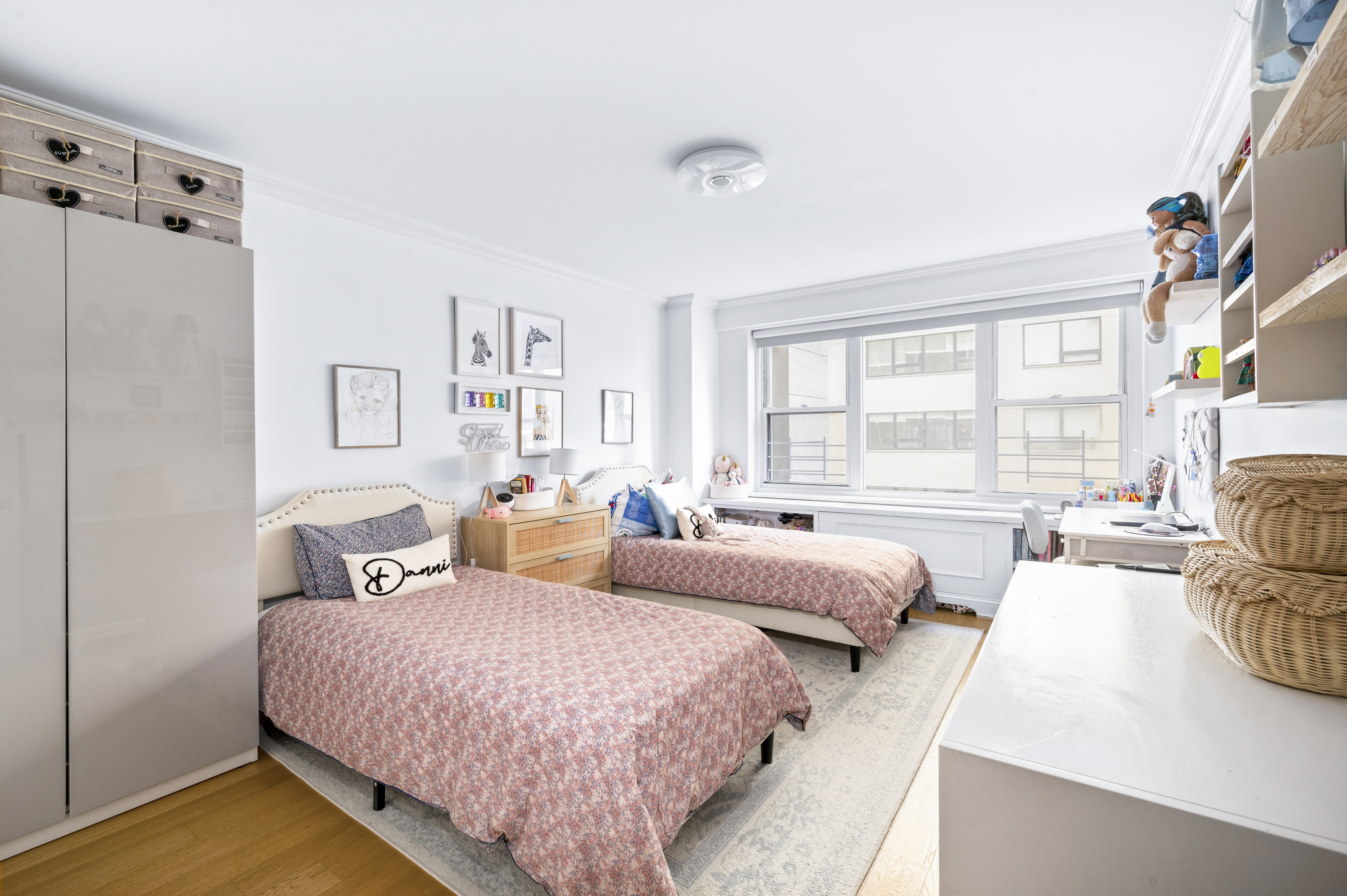 201 East 79th Street, Unit 6A Manhattan, NY 10075 - Photo 6 of 11 a spacious bedroom with two beds and a large window