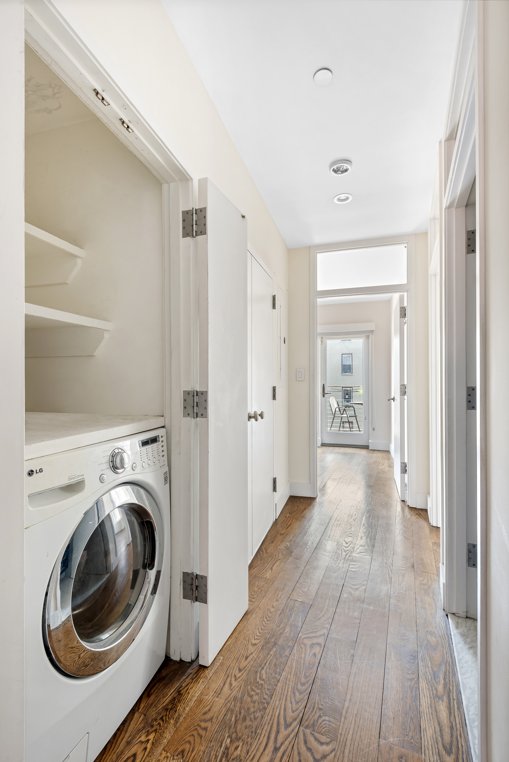 176 Mulberry Street, Unit 5 Manhattan, NY 10013 - Photo 6 of 12 a view of a hallway with washer and dryer