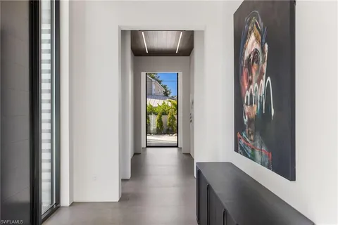 a view of an empty room with kitchen