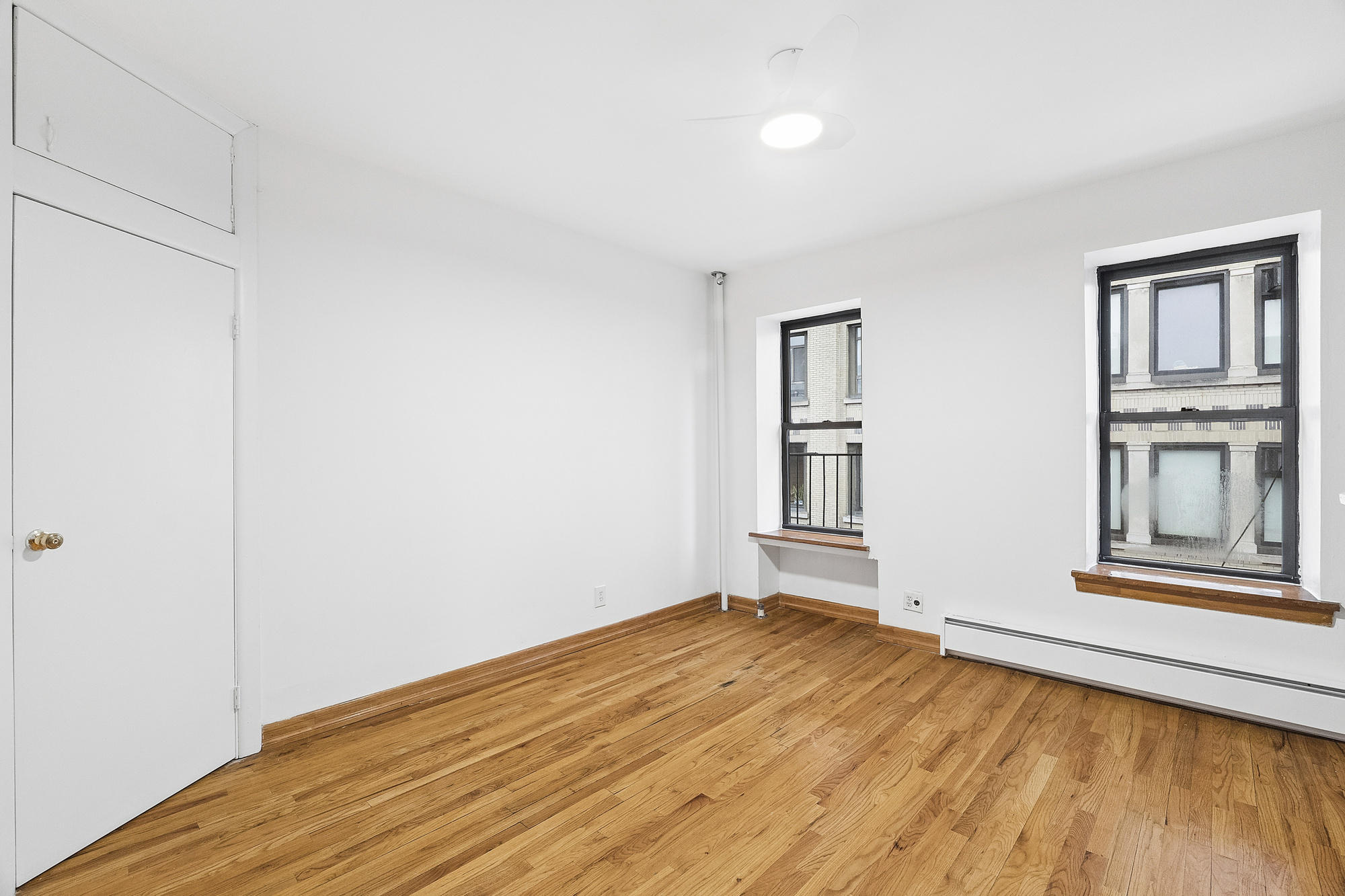 5 Cornelia Street, Unit 5B Manhattan, NY 10014 - Photo 2 of 7 a view of empty room with wooden floor and fan