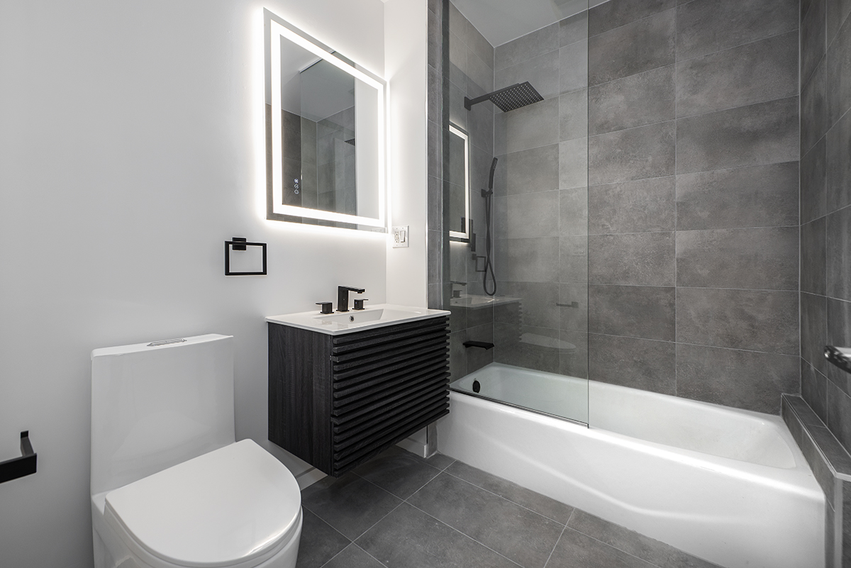 148 North 10th Street, Unit 5A Brooklyn, NY 11249 - Photo 5 of 9 a bathroom with a sink a toilet and bathtub