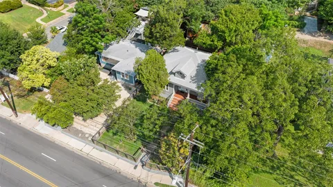 an aerial view of a house with yard