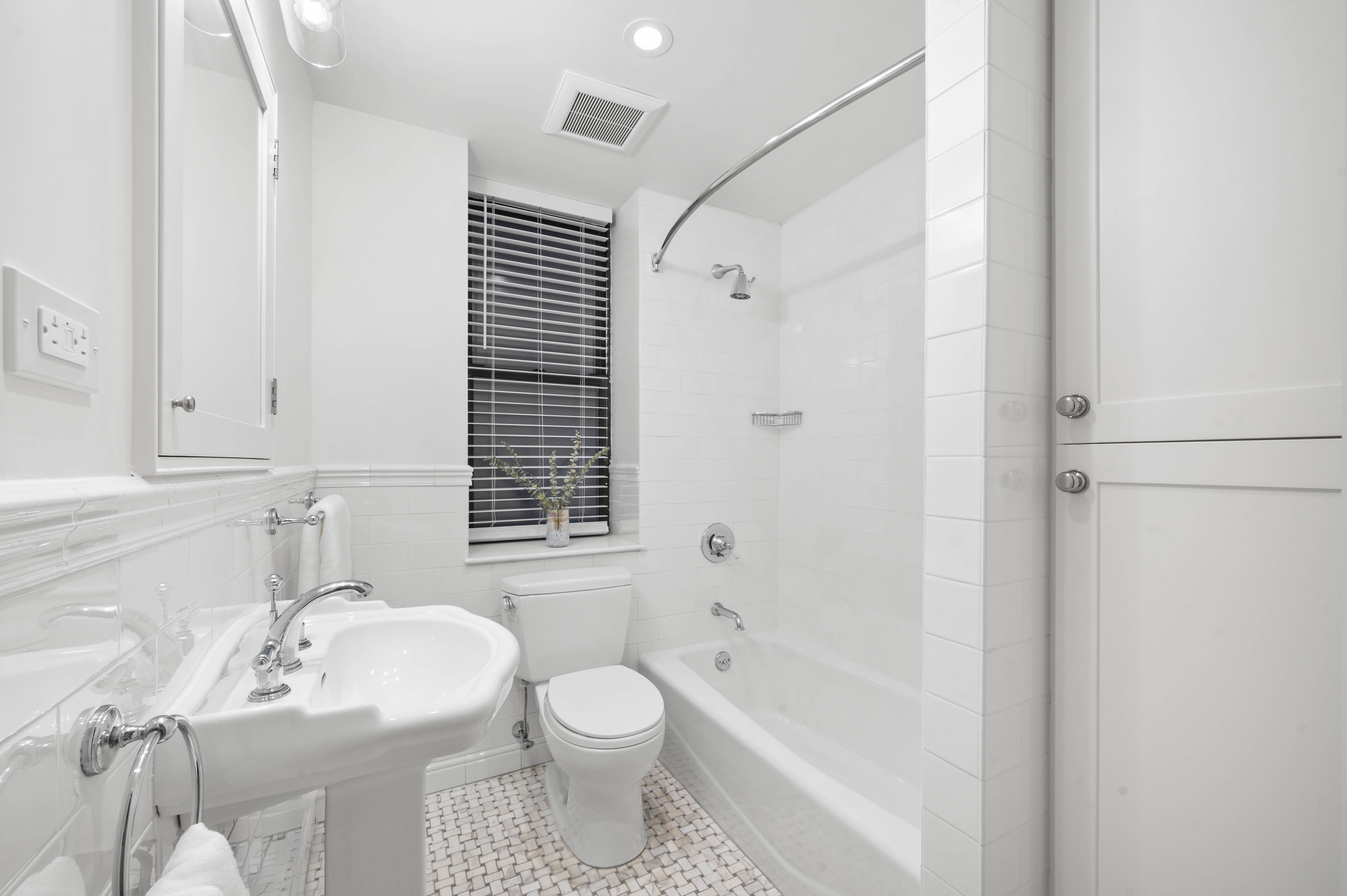444 East 58th Street, Unit 1C Manhattan, NY 10022 - Photo 7 of 9 a bathroom with a sink toilet a shower and a mirror