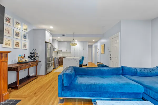 a living room with furniture and kitchen view