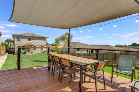 a view of a chairs and table in patio of the house