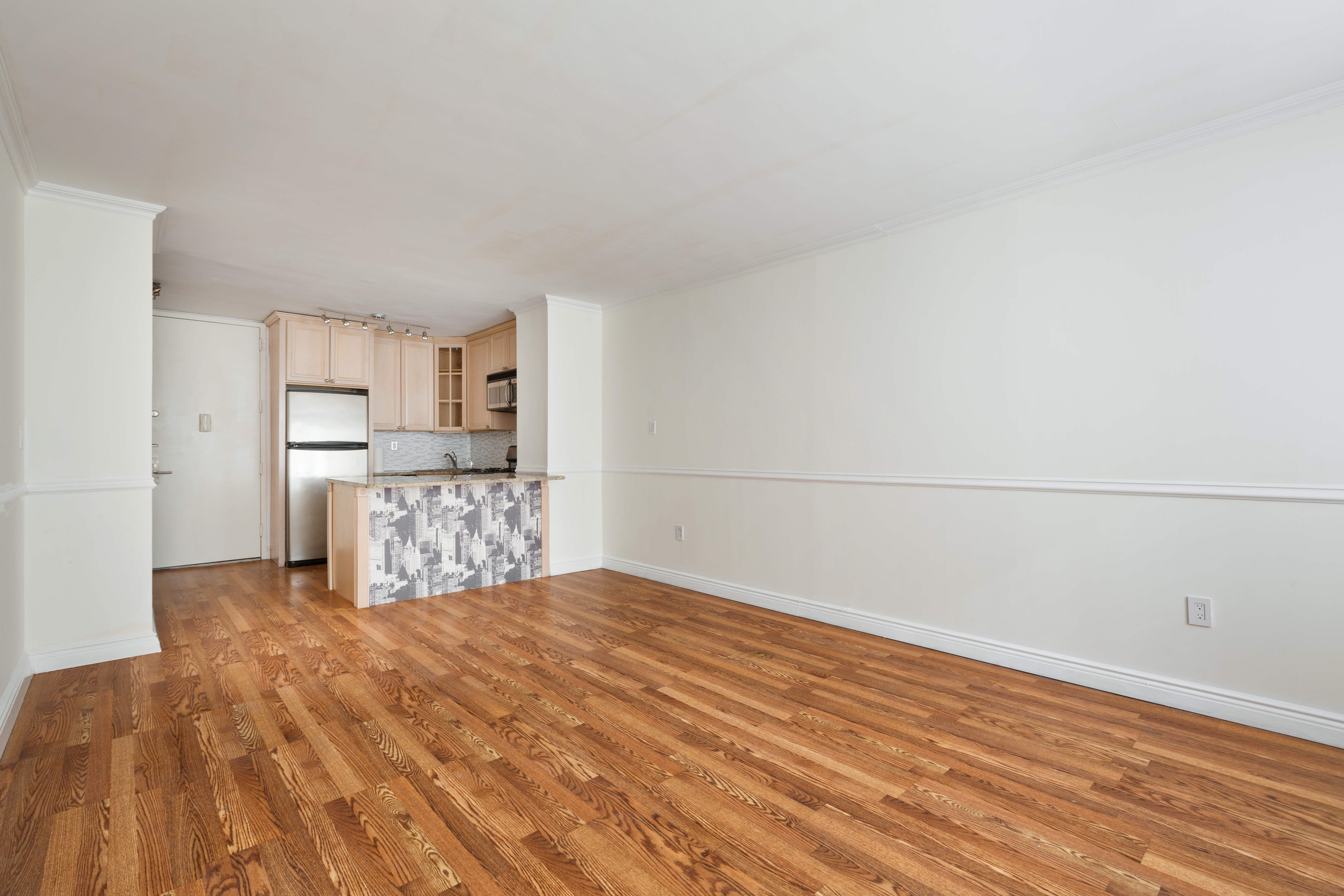 280 Park Avenue South, Unit 4F Manhattan, NY 10010 - Photo 4 of 7 a view of a kitchen with wooden floor
