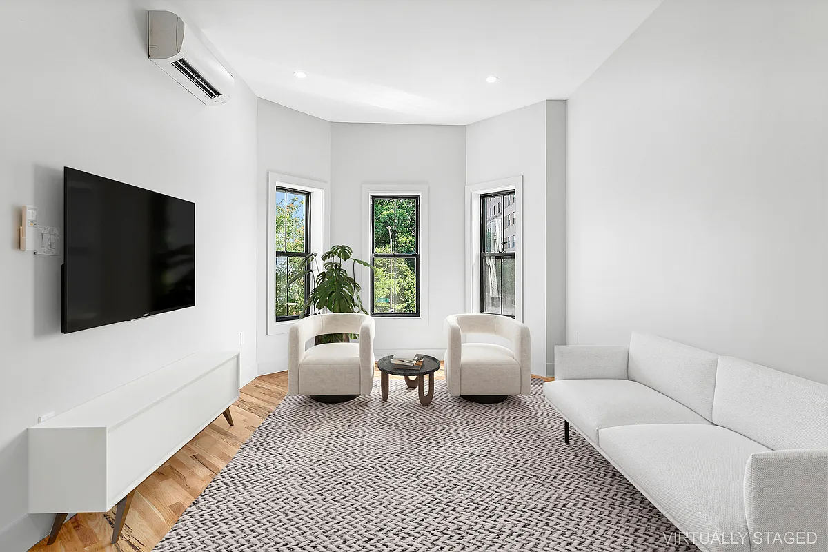 866 Bushwick Avenue, Unit 1 Brooklyn, NY 11221 - Photo 3 of 13 a living room with furniture and a flat screen tv