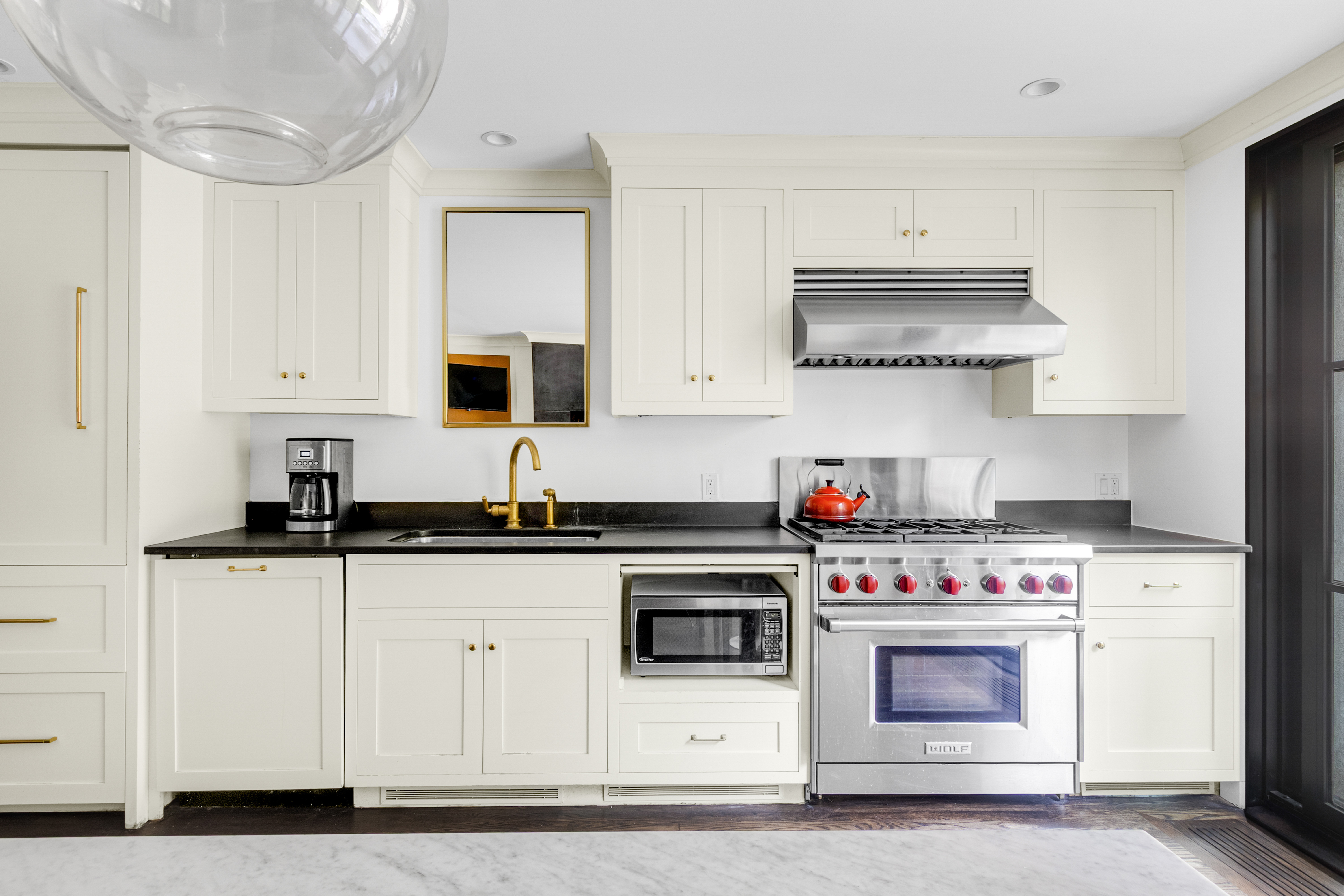 125 West 132nd Street Manhattan, NY 10027 - Photo 6 of 21 a kitchen with cabinets appliances and a sink