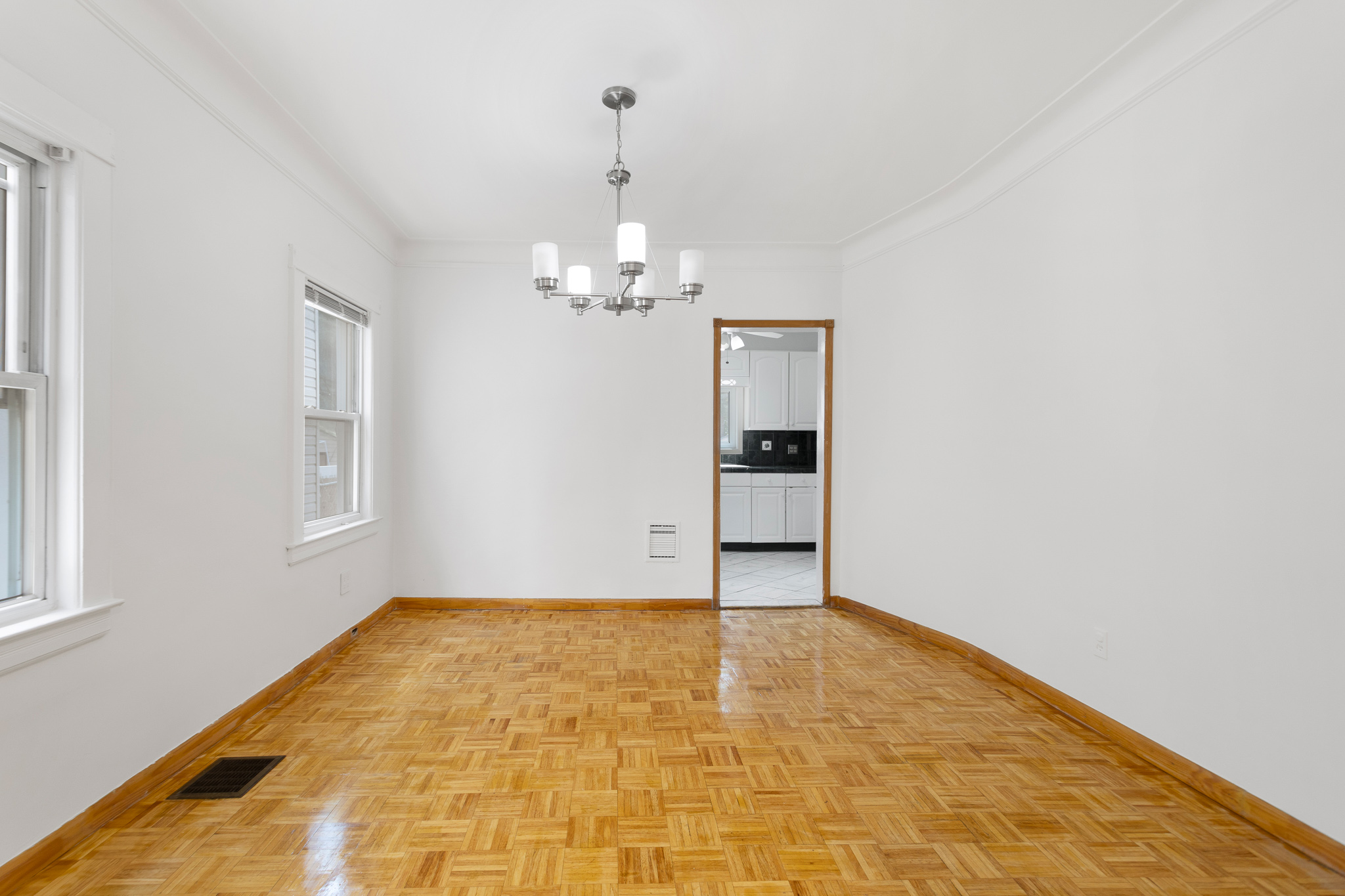91-22 92nd Street Queens, NY 11421 - Photo 15 of 27 a view of an empty room with wooden floor