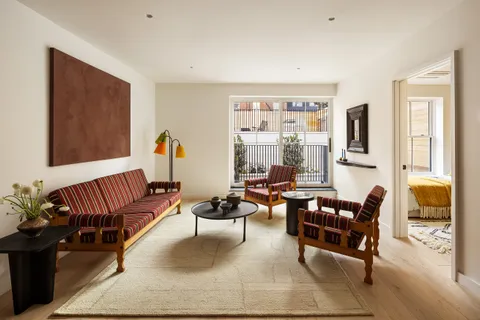 a living room with furniture ceiling fan and a window