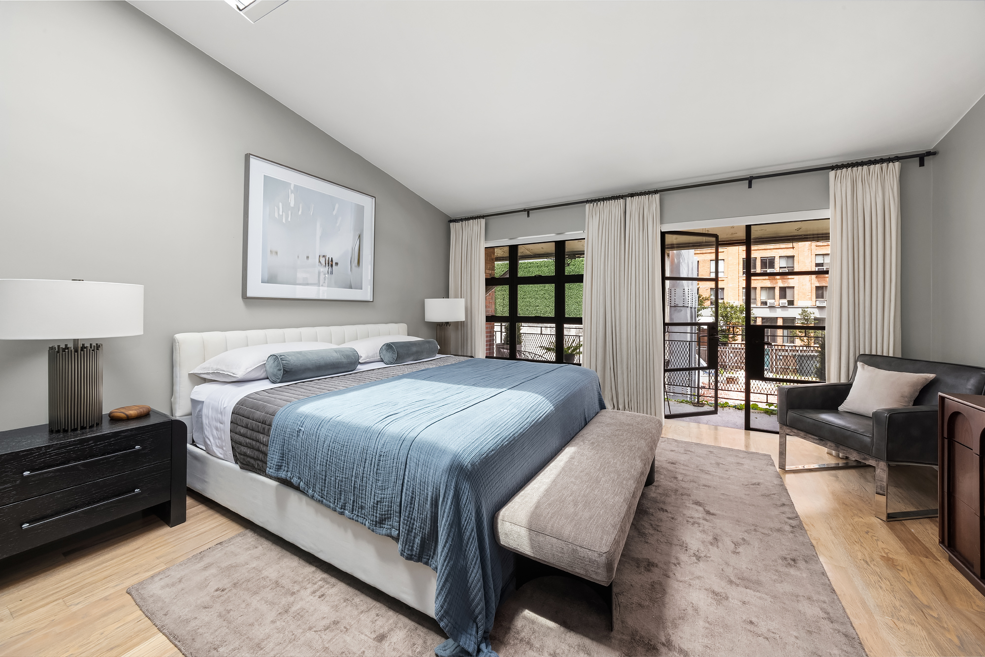 8 Charles Lane, Unit C Manhattan, NY 10014 - Photo 11 of 20 a spacious bedroom with a bed and wooden floor