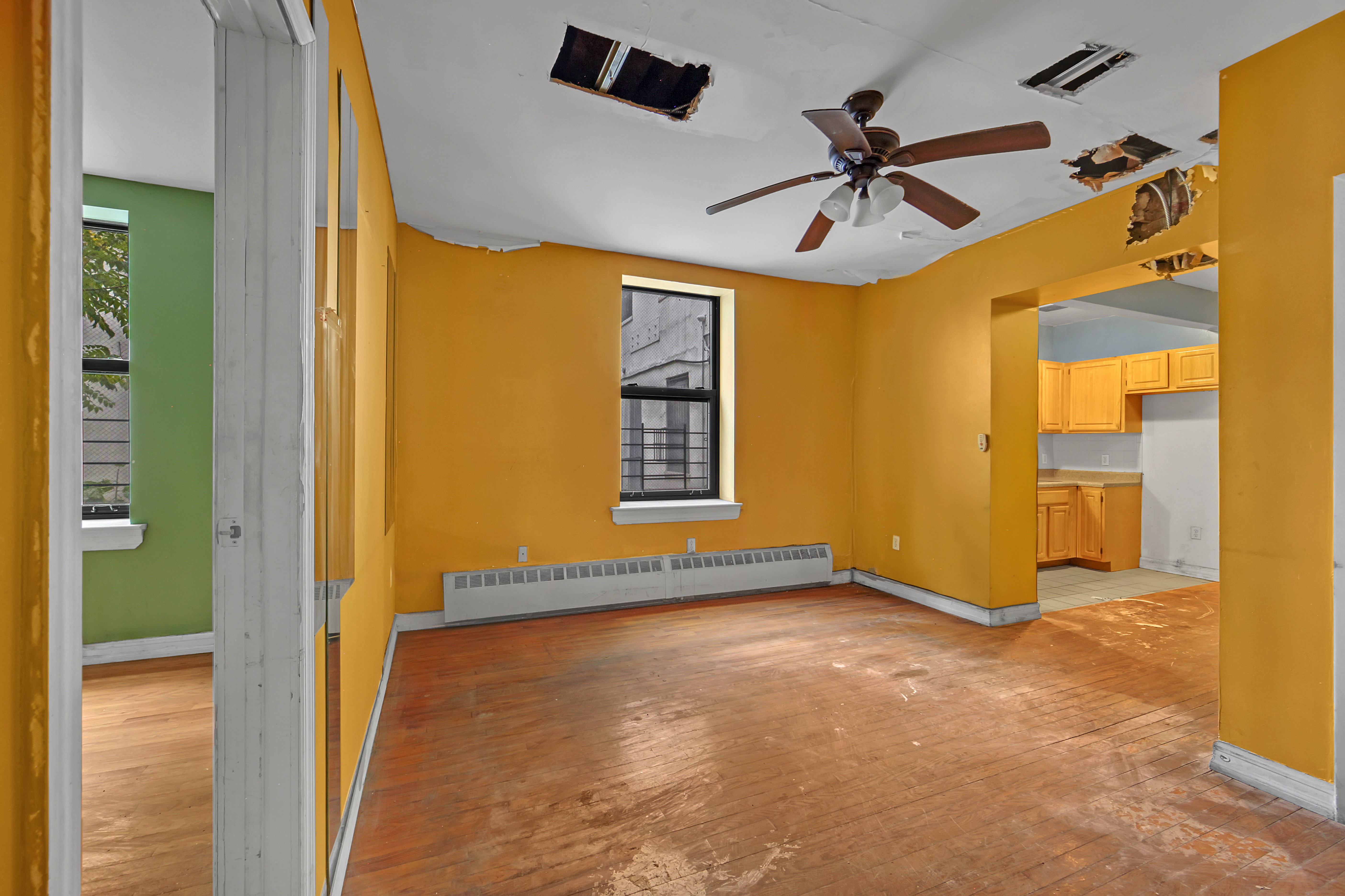 430 Lenox Avenue, Unit 1 Manhattan, NY 10037 - Photo 6 of 14 an empty room with windows and ceiling fan