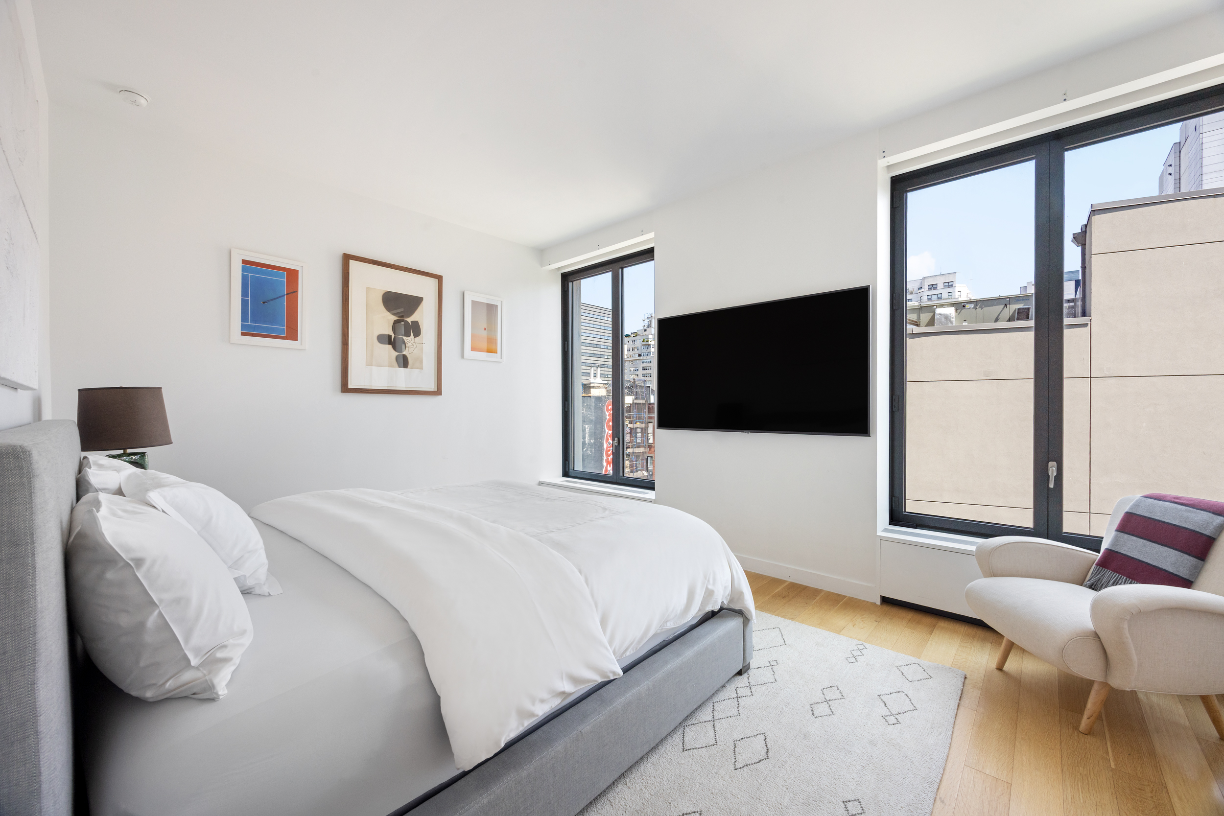 21 East 12th Street, Unit 8A Manhattan, NY 10003 - Photo 9 of 20 a bedroom with a bed and a flat screen tv