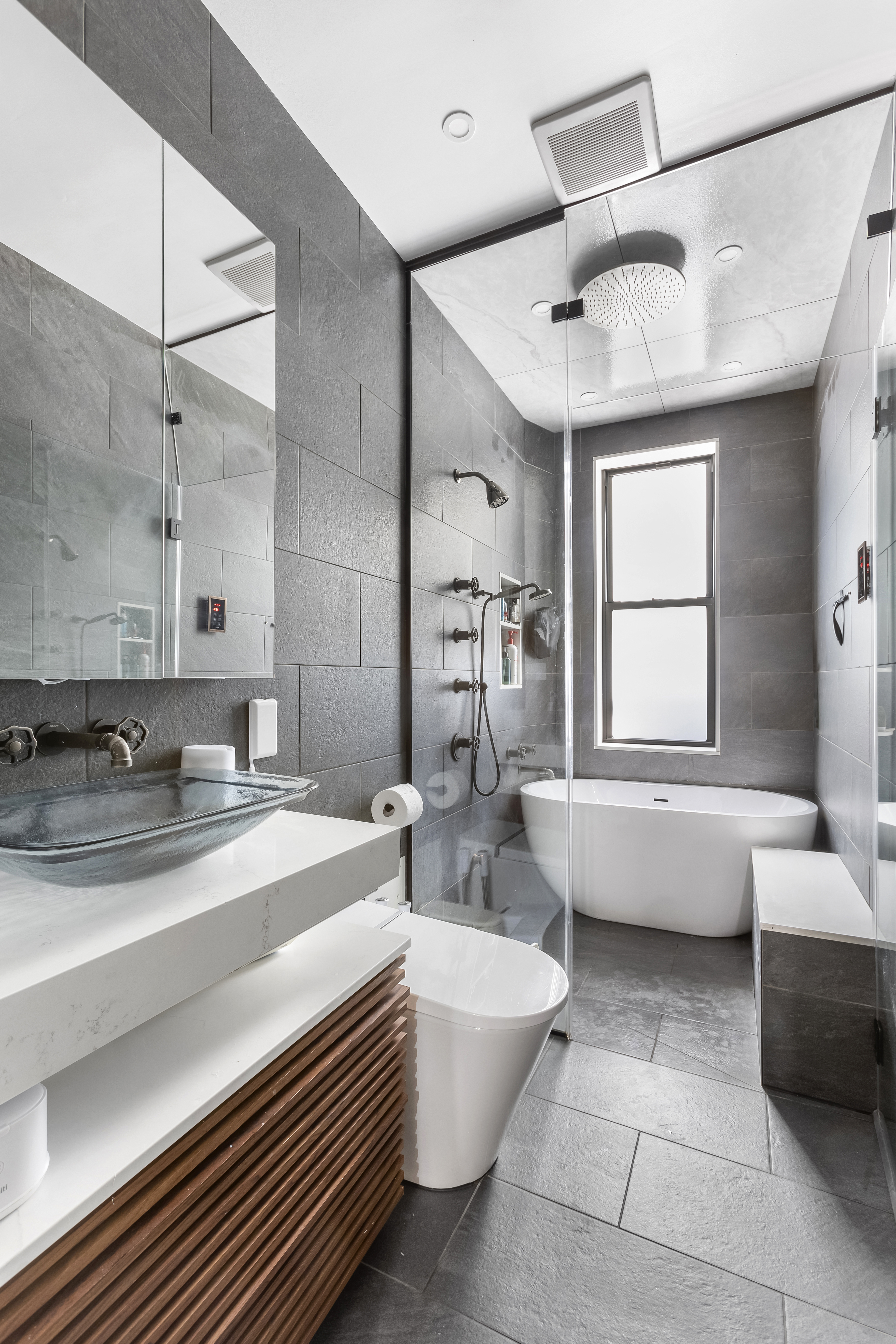 312 10th Street Brooklyn, NY 11215 - Photo 13 of 17 a spacious bathroom with a bathtub sink and mirror