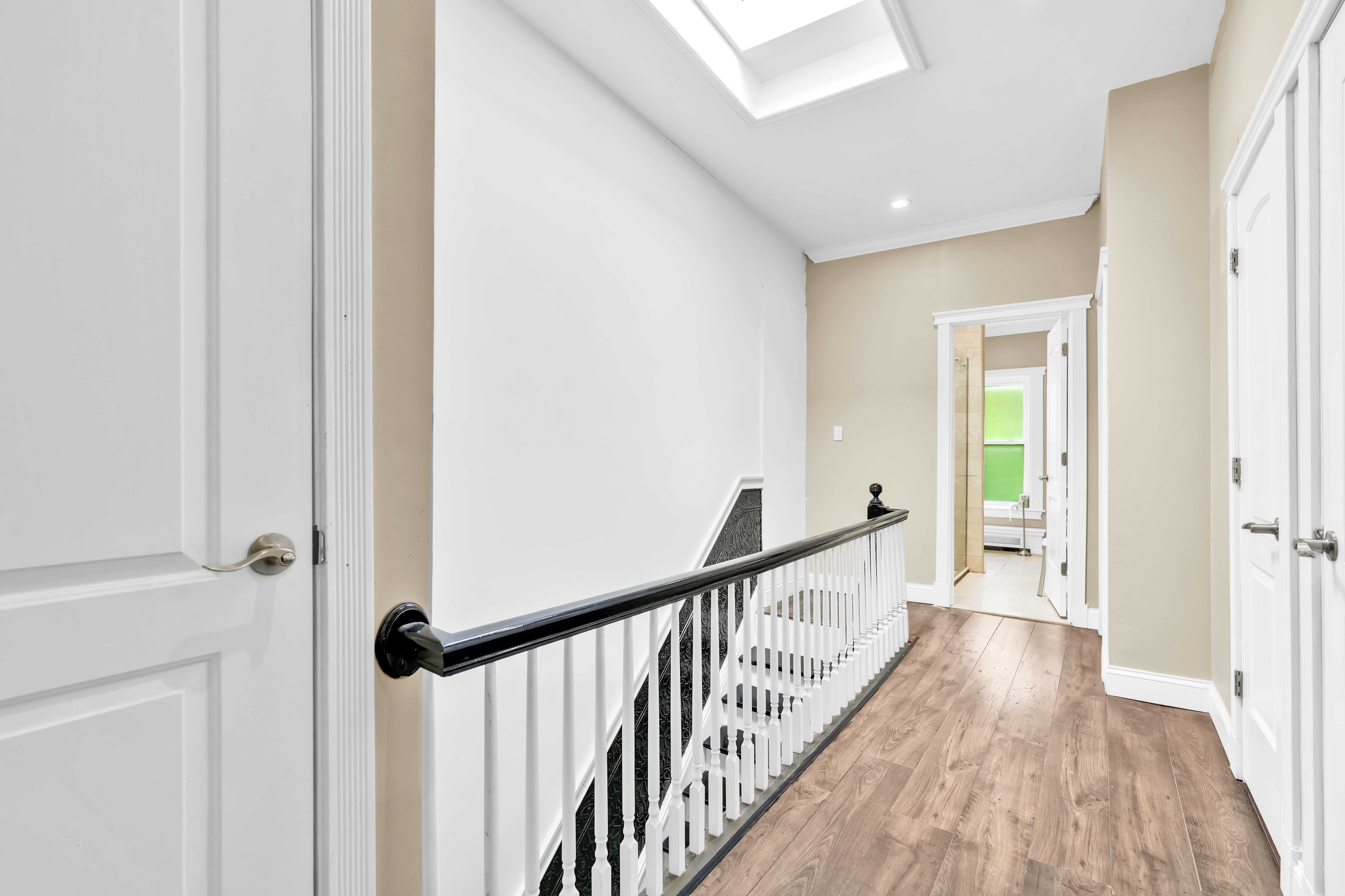 519 Monroe Street Brooklyn, NY 11221 - Photo 19 of 55 a view of a hallway with wooden floor and staircase