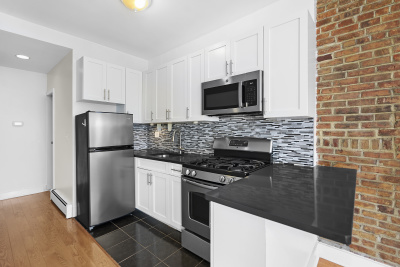 67 Gates Avenue, Unit 2 Brooklyn, NY 11238 - Photo 1 of 4 a kitchen with a refrigerator stove and microwave