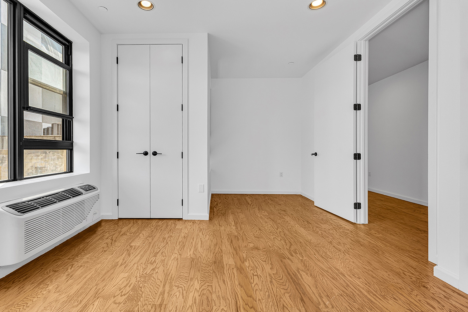 452 Lafayette Avenue, Unit 4R Brooklyn, NY 11205 - Photo 13 of 15 a view of an empty room with window and wooden floor