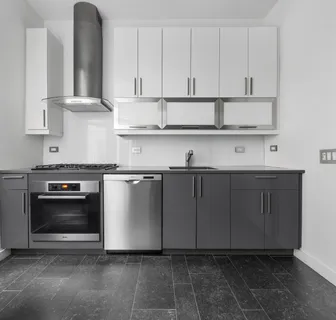 a kitchen with stainless steel appliances granite countertop a sink a stove and a refrigerator