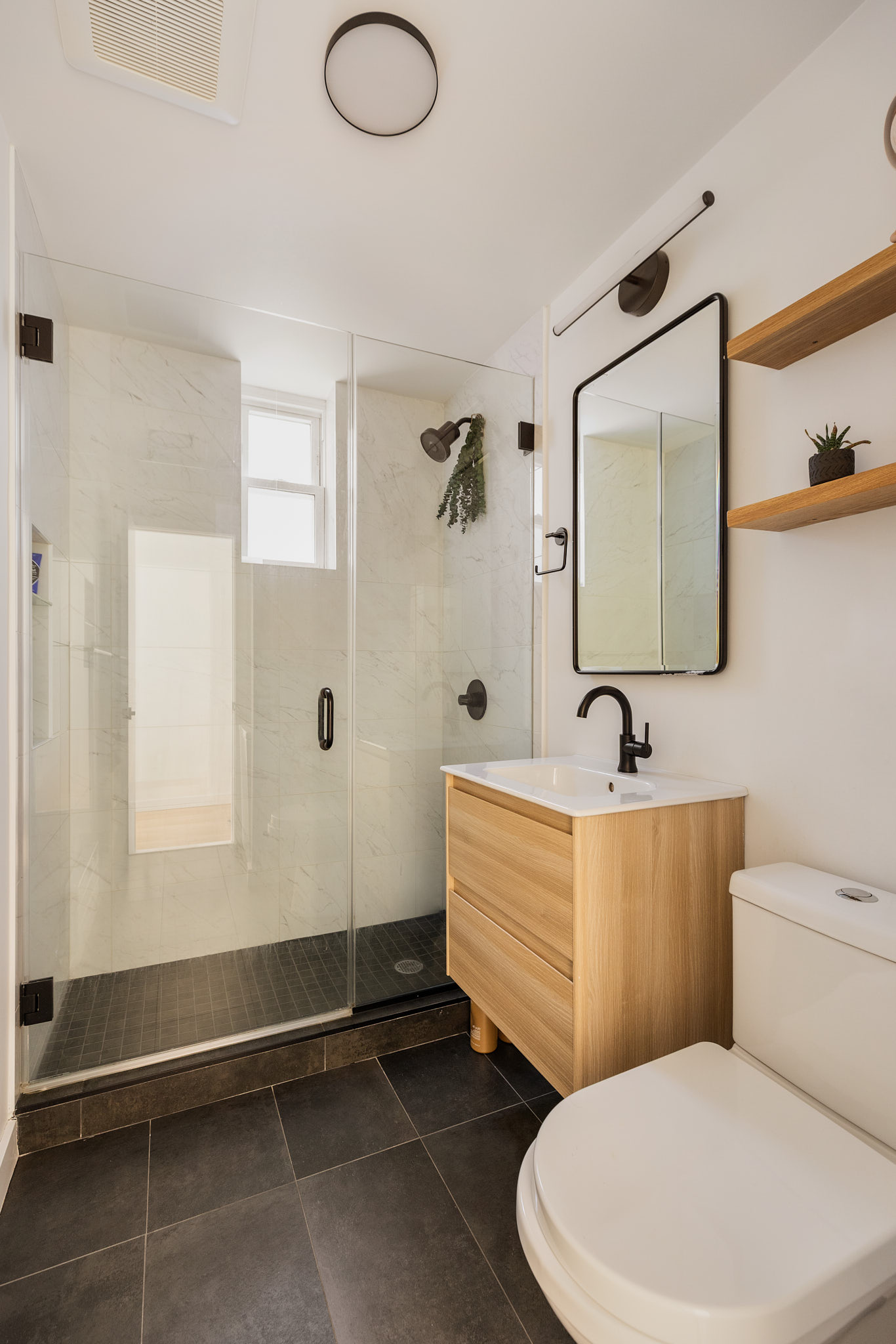 182 Mulberry Street, Unit 4 Manhattan, NY 10012 - Photo 12 of 13 a bathroom with a toilet a sink and mirror