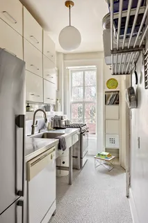 a view of a kitchen with a sink and windows