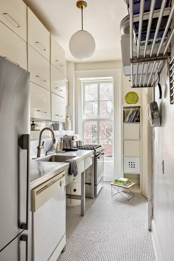 a view of a kitchen with a sink and windows