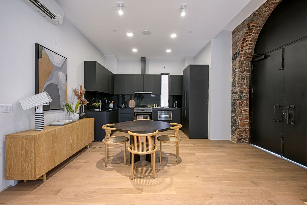 459 Harman Street, Unit 1 Manhattan, NY 10026 - Photo 3 of 17 a kitchen with stainless steel appliances kitchen island granite countertop a refrigerator and a stove top oven