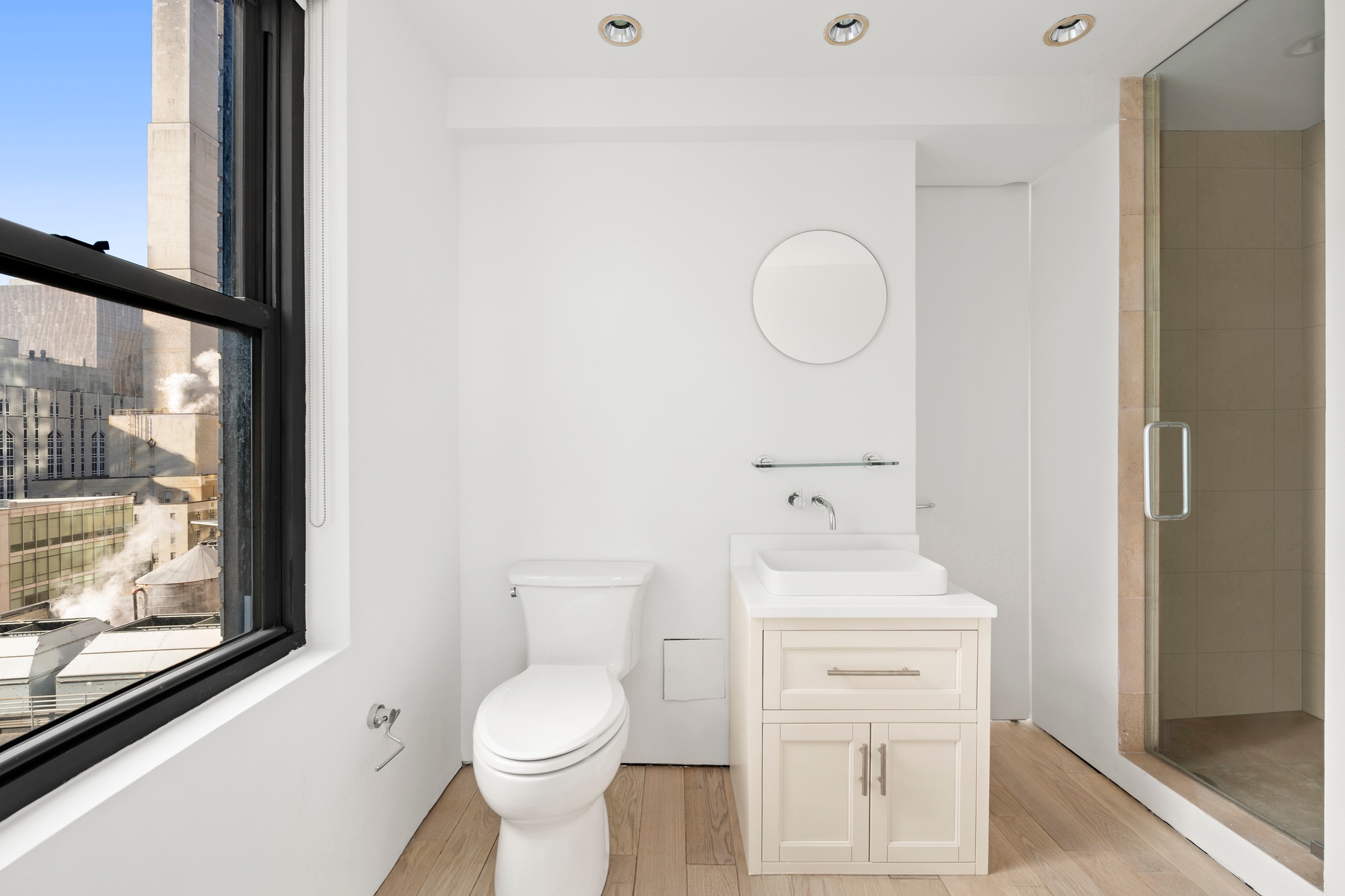 530 East 72nd Street, Unit 14E Manhattan, NY 10021 - Photo 17 of 19 a bathroom with a toilet a sink and a mirror