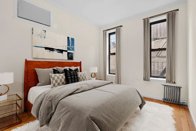 370 Columbus Avenue, Unit 2J Manhattan, NY 10024 - Photo 3 of 9 a bedroom with a bed and wooden floor