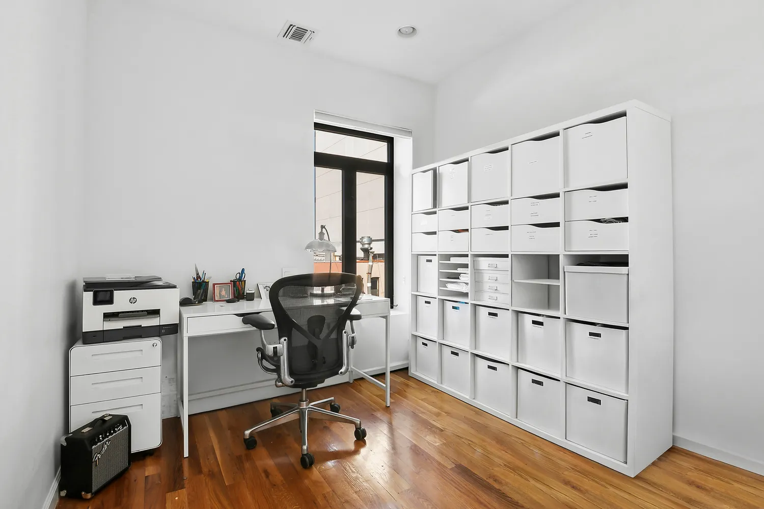a view of workspace with wooden floor windows