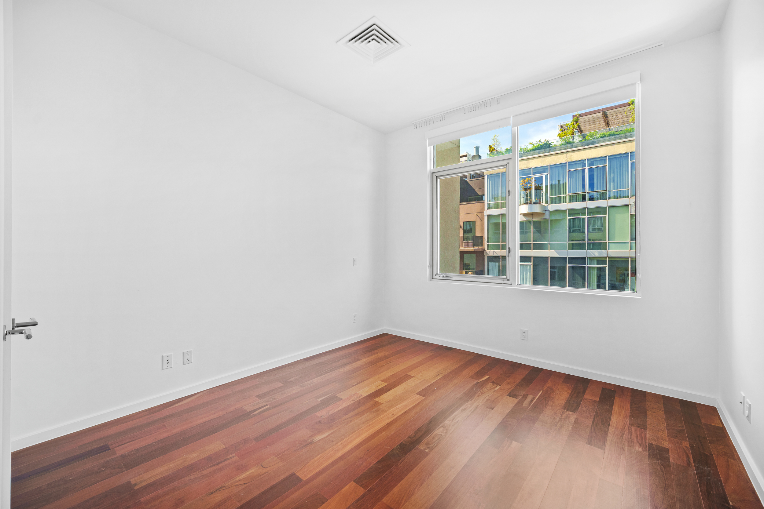 170 North 11th Street, Unit 5B Brooklyn, NY 11211 - Photo 5 of 11 a view of an empty room with a window and wooden floor