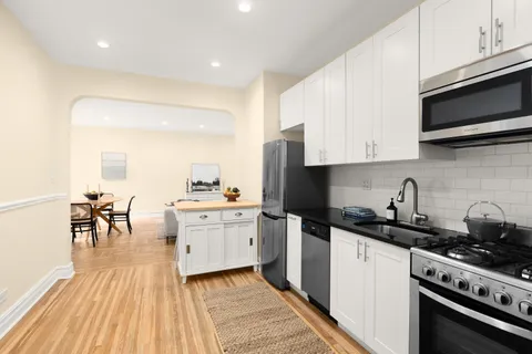 a kitchen with a sink a stove and cabinets