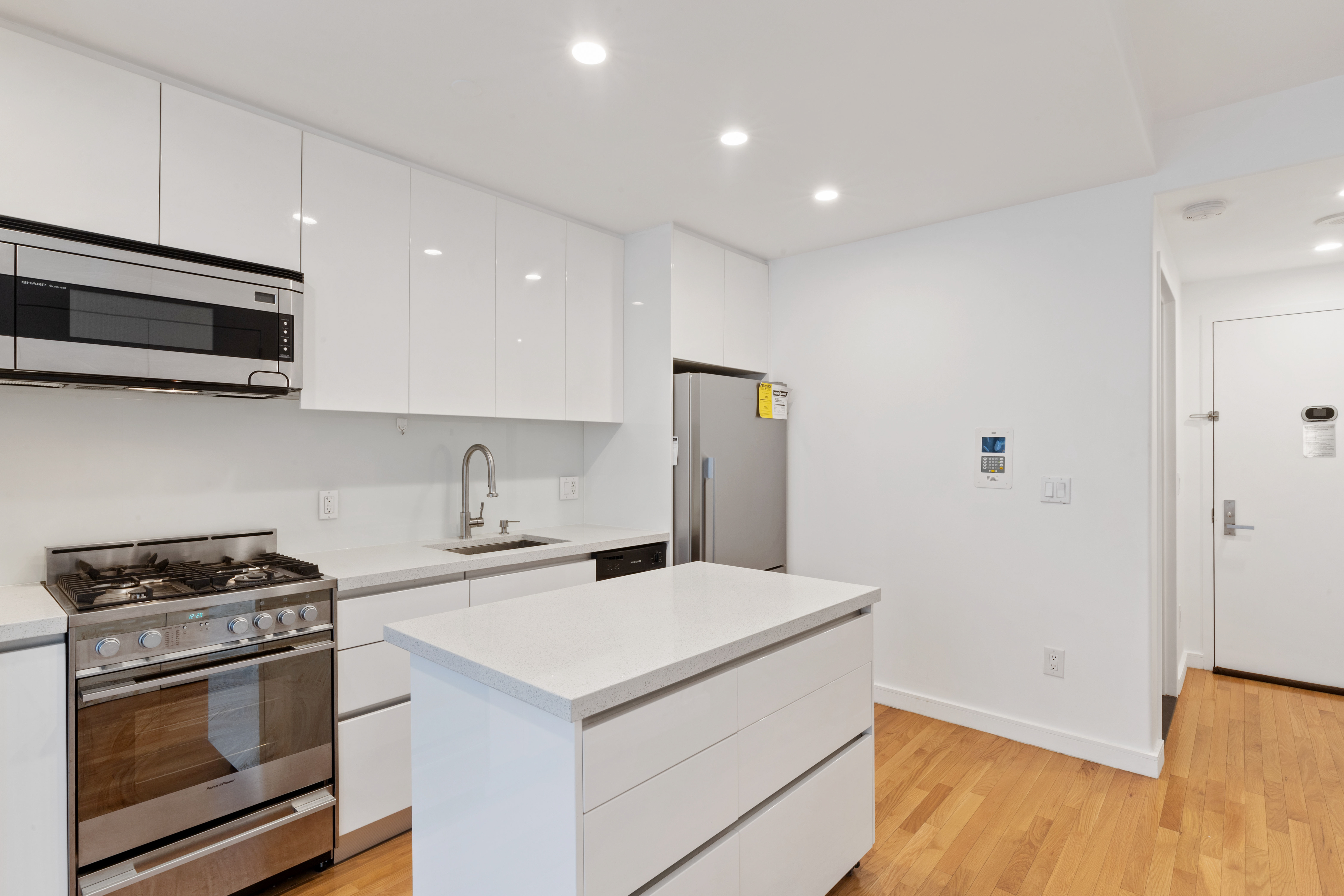148 East 24th Street, Unit 4C Manhattan, NY 10010 - Photo 6 of 15 a kitchen with a stove and a microwave