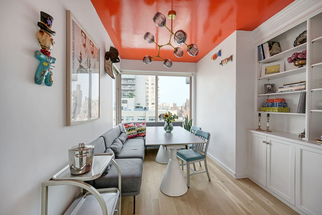 200 East 69th Street, Unit 21C Manhattan, NY 10021 - Photo 7 of 16 a dining room with furniture a rug and a window
