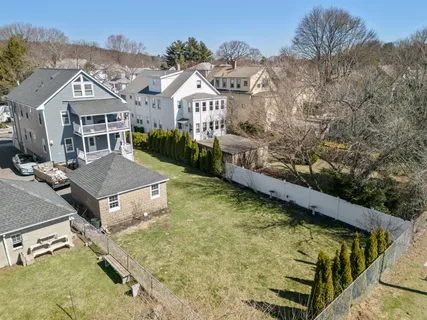 a view of residential houses with yard and stairs