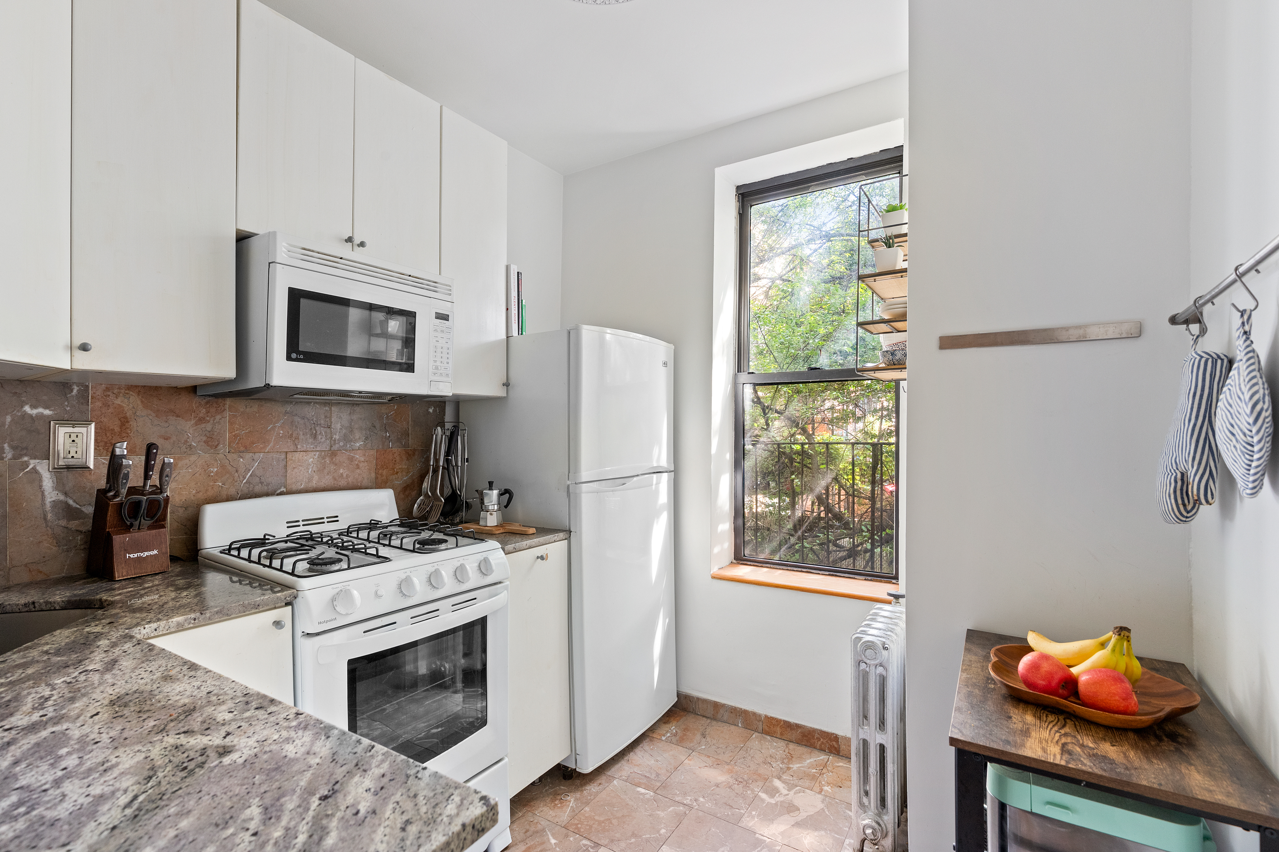 347 5th Avenue, Unit 2L Brooklyn, NY 11215 - Photo 4 of 5 a kitchen with white cabinets and appliances