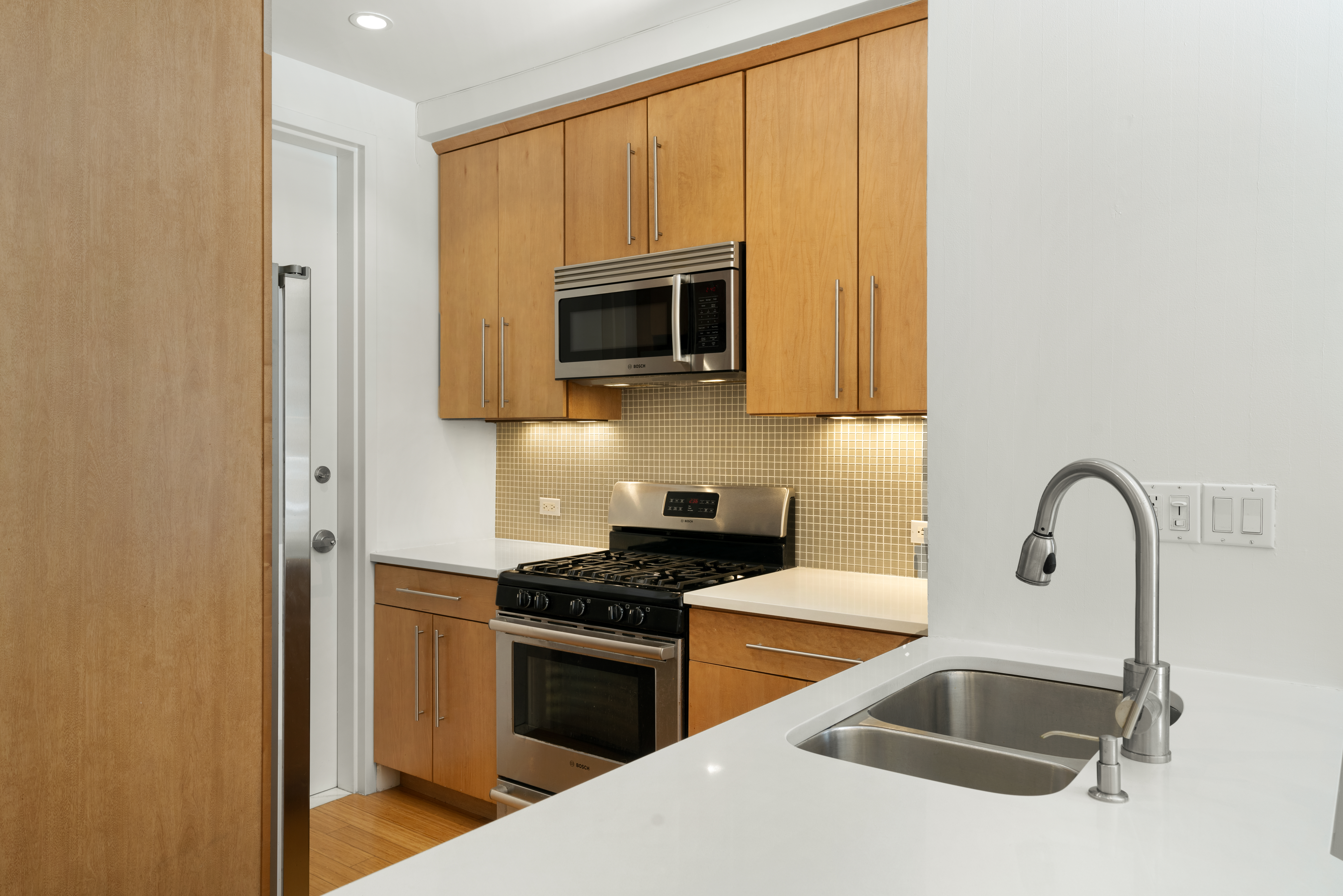 a kitchen with granite countertop a stove and a microwave
