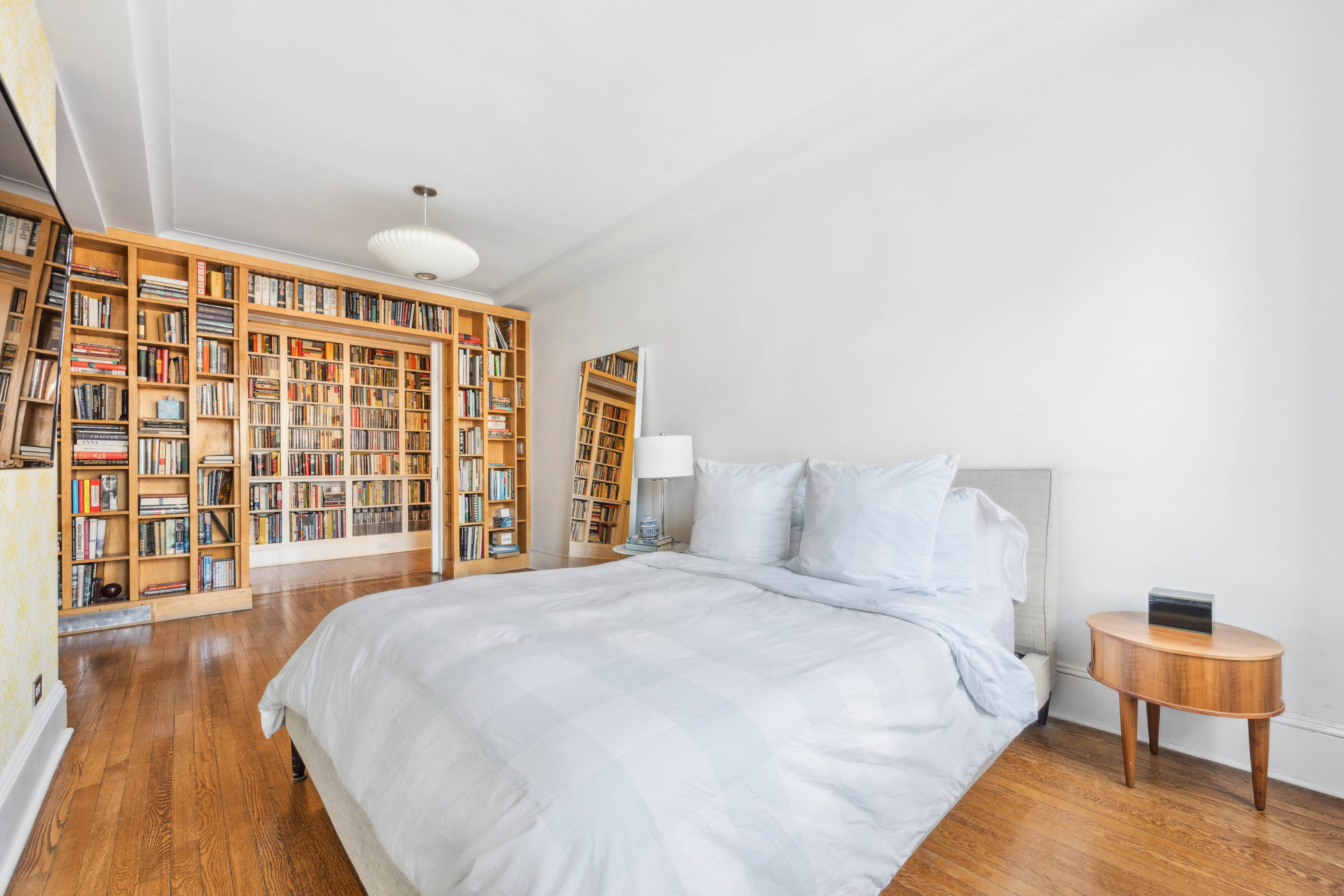 136 East 36th Street, Unit 9/10C Manhattan, NY 10016 - Photo 12 of 27 a spacious bedroom with a bed and a large window