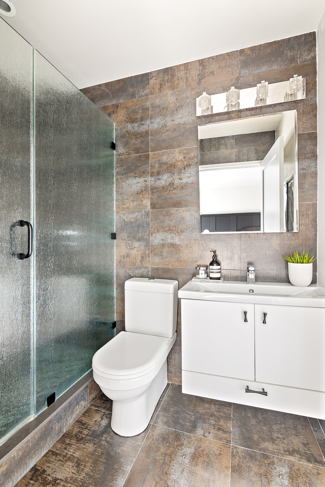 447 West 45th Street, Unit 5A Manhattan, NY 10036 - Photo 6 of 12 a bathroom with a sink a toilet and shower