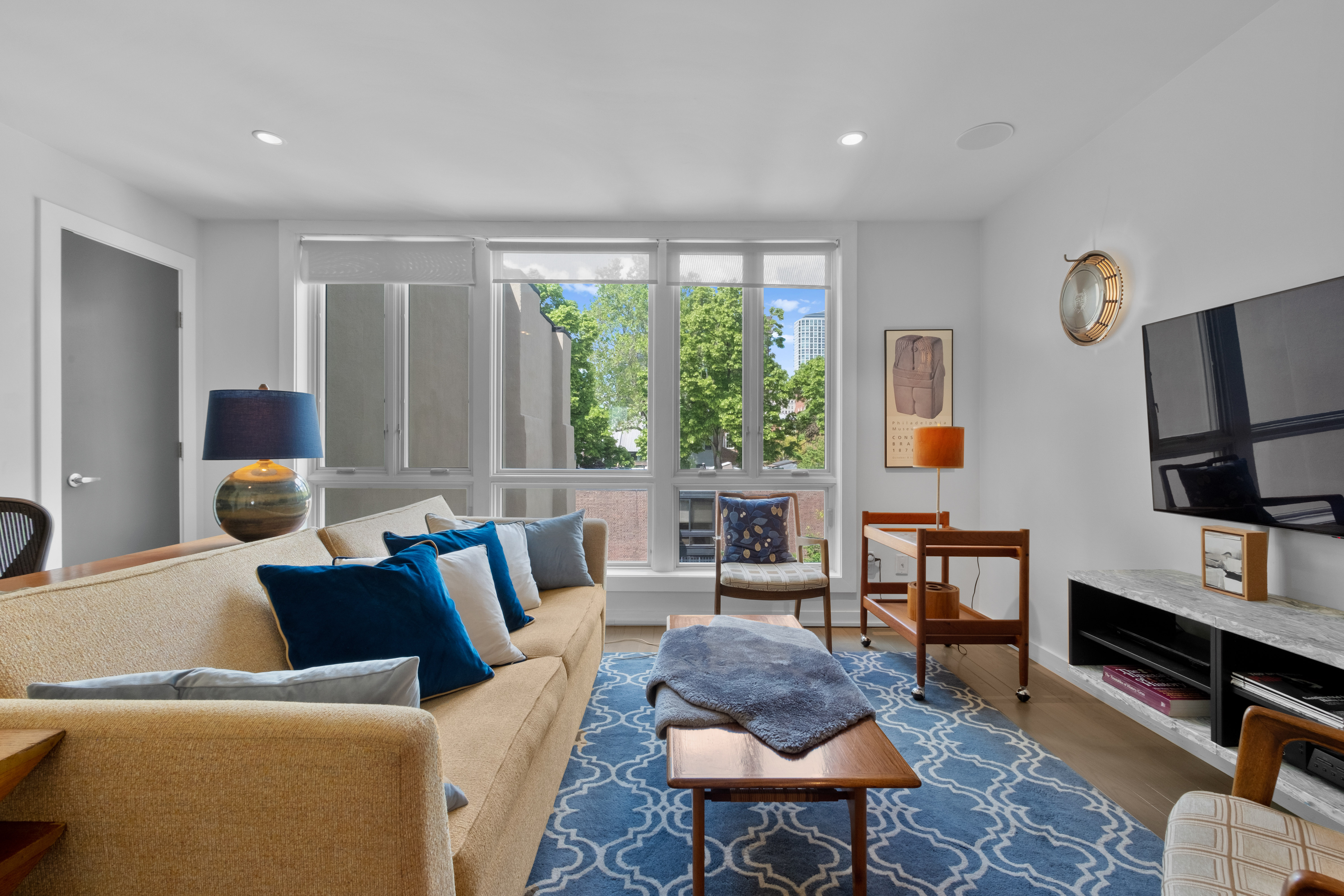 256 1/2 South 3rd Street Philadelphia, PA 19106 - Photo 30 of 73 a living room with furniture a flat screen tv and a window