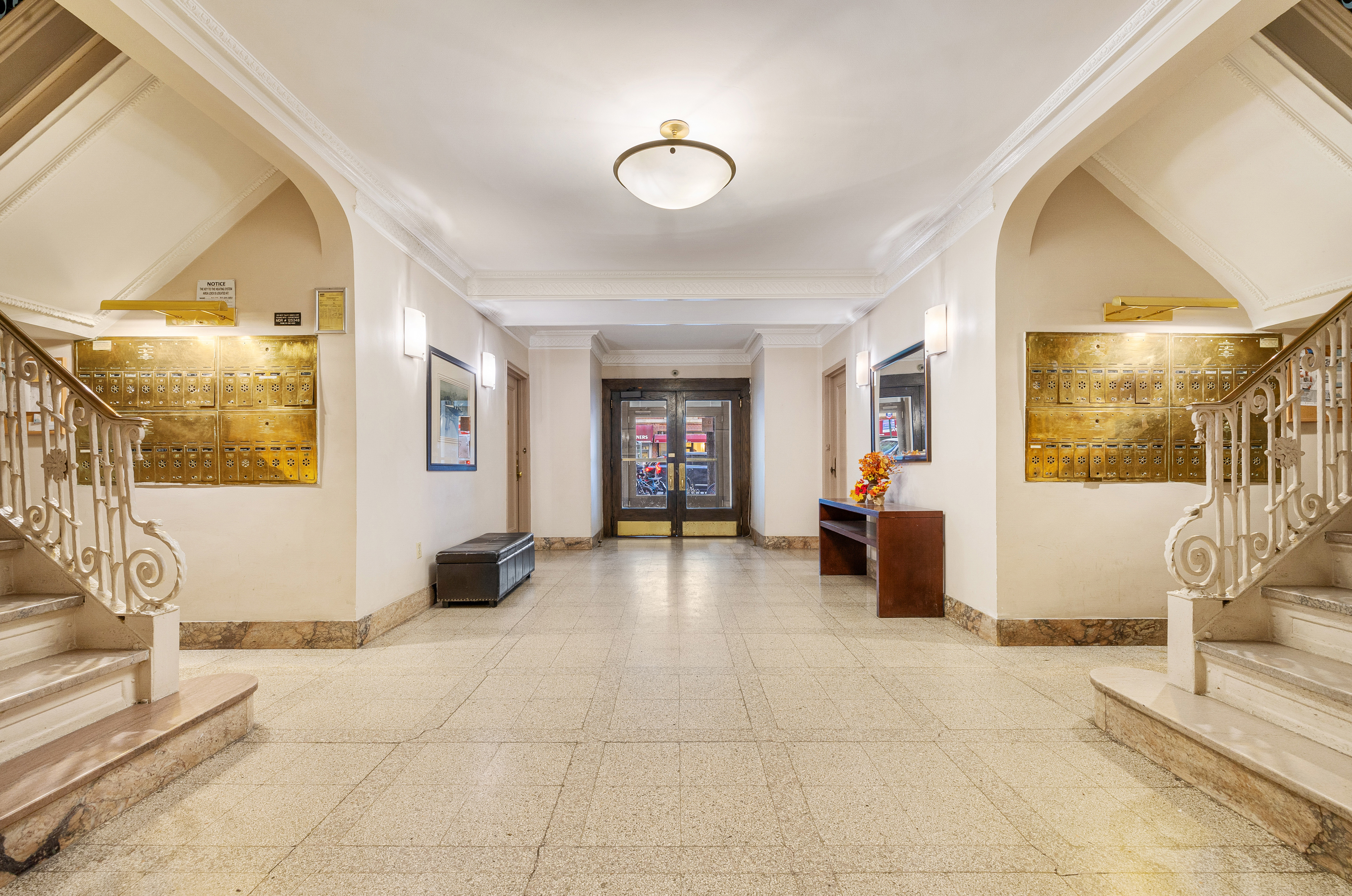 269 West 72nd Street, Unit 9B Manhattan, NY 10023 - Photo 10 of 13 a view of a entryway door with living room and couch