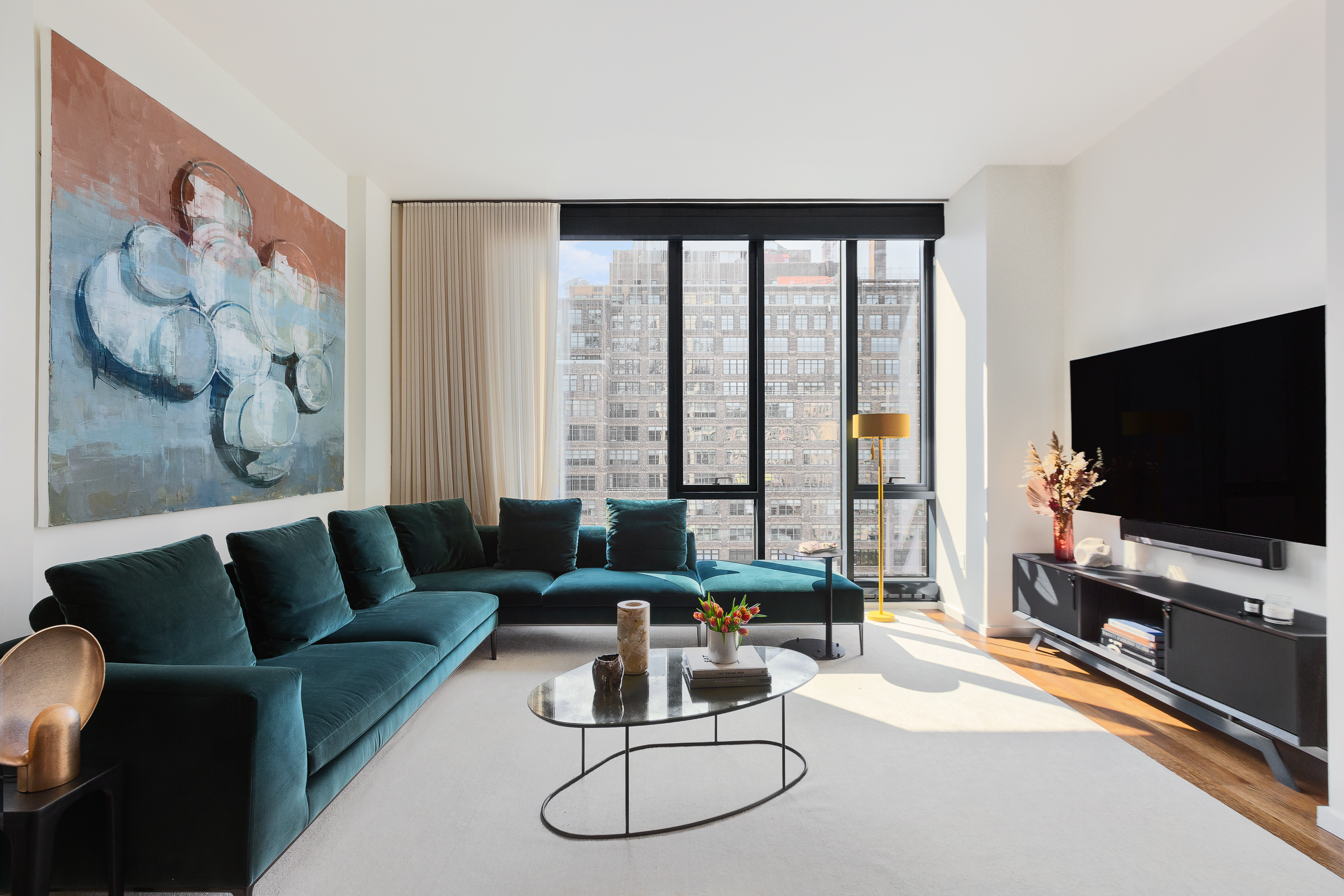 570 Broome Street, Unit 11B Manhattan, NY 10013 - Photo 1 of 2 a living room with furniture and a flat screen tv