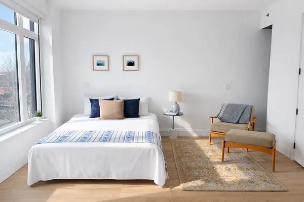 a bedroom with a bed and window