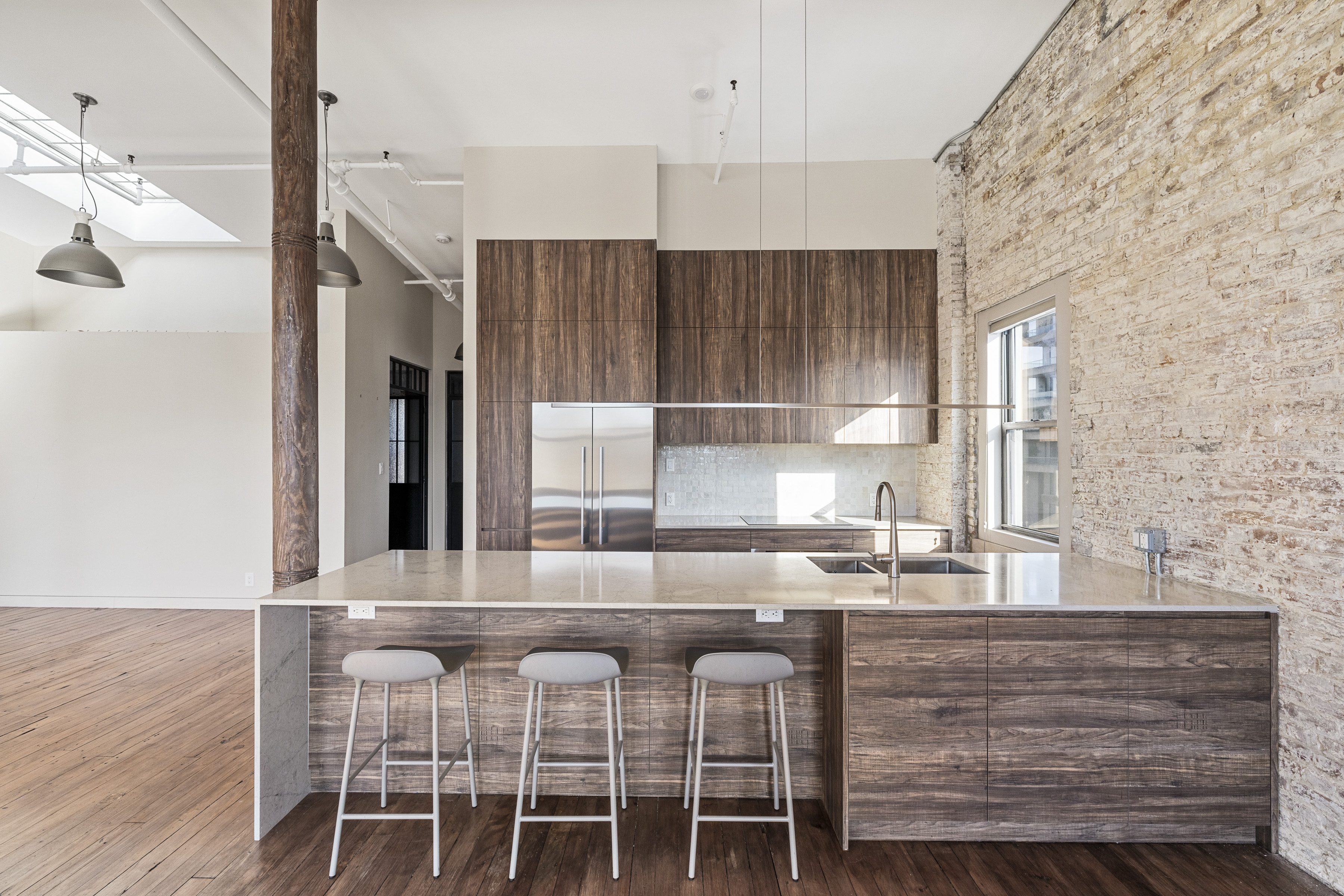 705 Driggs Avenue, Unit 13 Brooklyn, NY 11211 - Photo 6 of 15 a kitchen with a table chairs refrigerator and cabinets