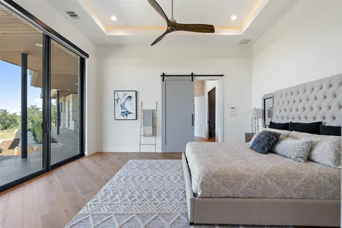 a bedroom with a large bed and a large mirror