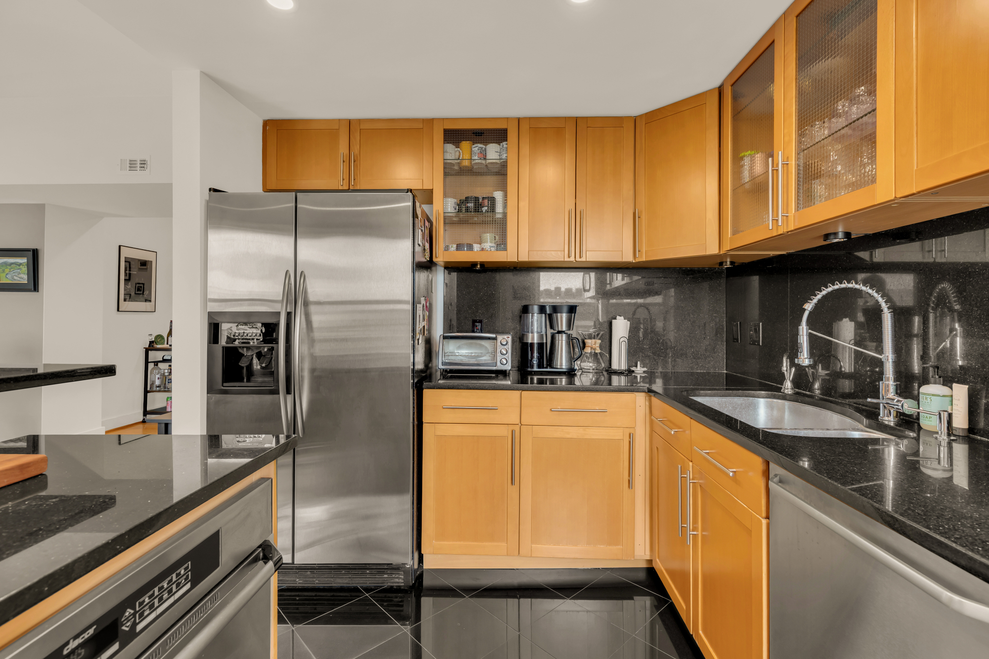 2127 California Street Northwest, Unit 505 Washington, DC 20008 - Photo 23 of 40 a kitchen with stainless steel appliances granite countertop a sink refrigerator and cabinets