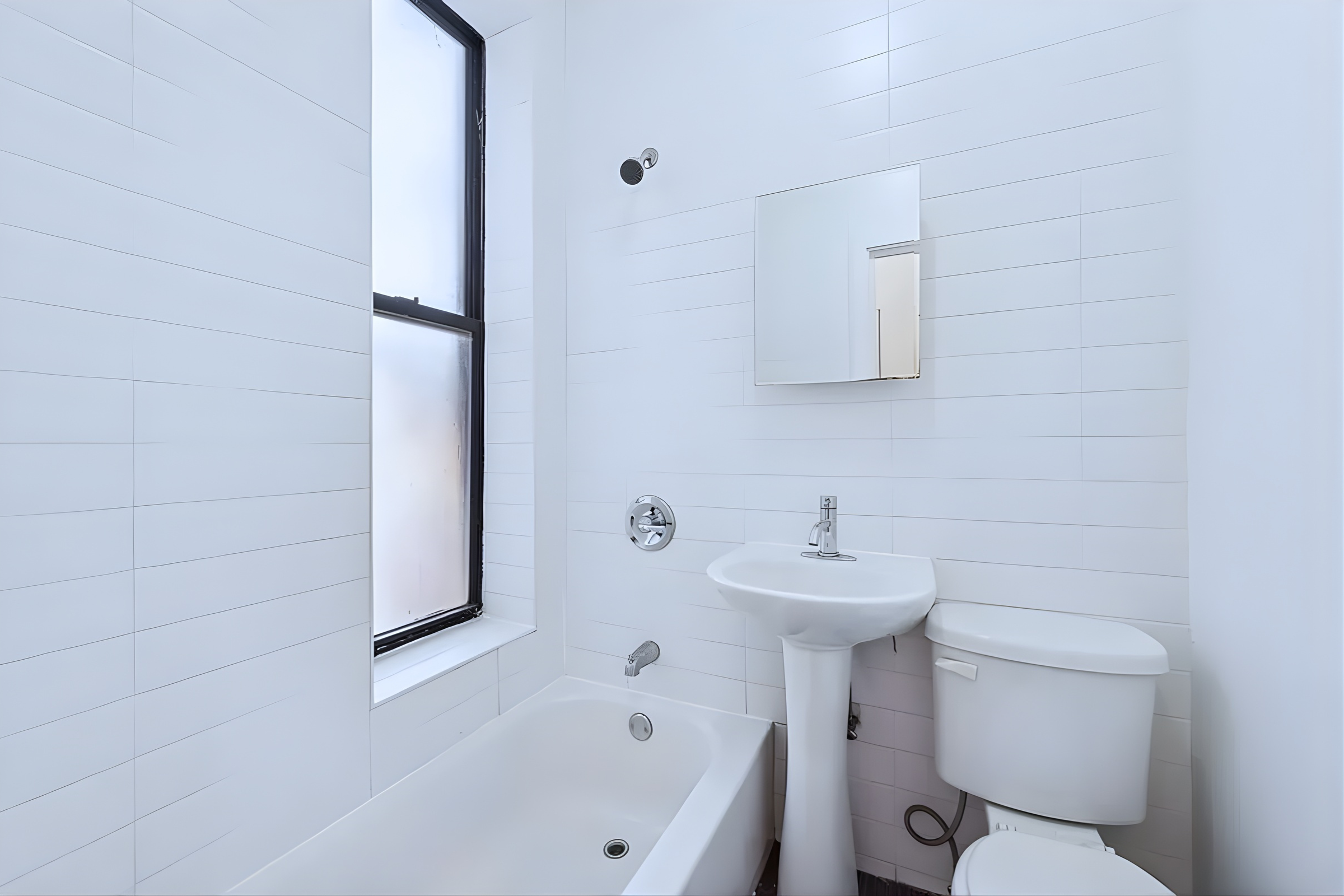 66 West 138th Street, Unit 5B Manhattan, NY 10037 - Photo 4 of 5 a bathroom with a sink a toilet and mirror