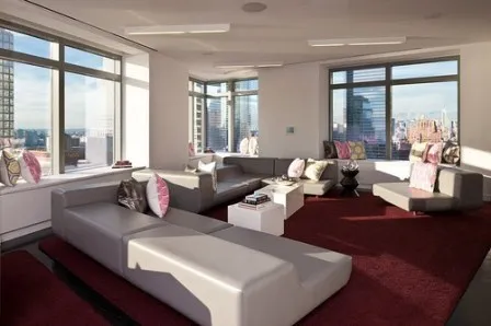 a living room with furniture and large windows