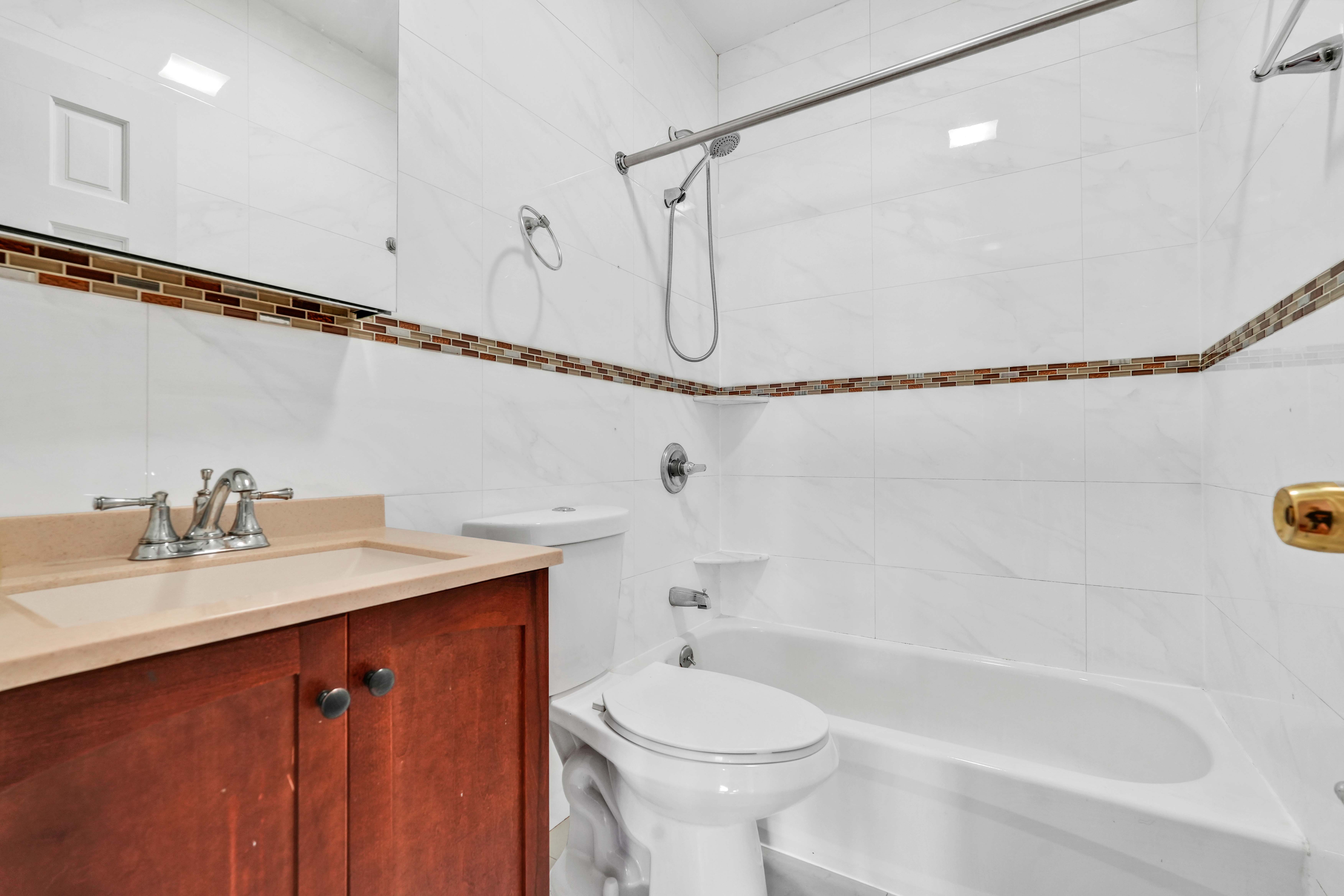 1892 Bergen Street, Unit 2 Brooklyn, NY 11233 - Photo 13 of 24 a bathroom with a sink a toilet and shower