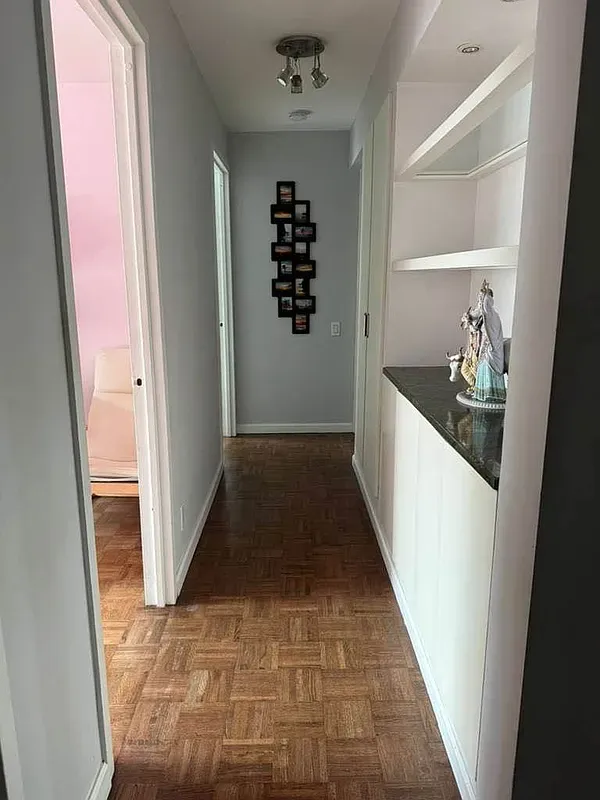 a view of room with window and wooden floor