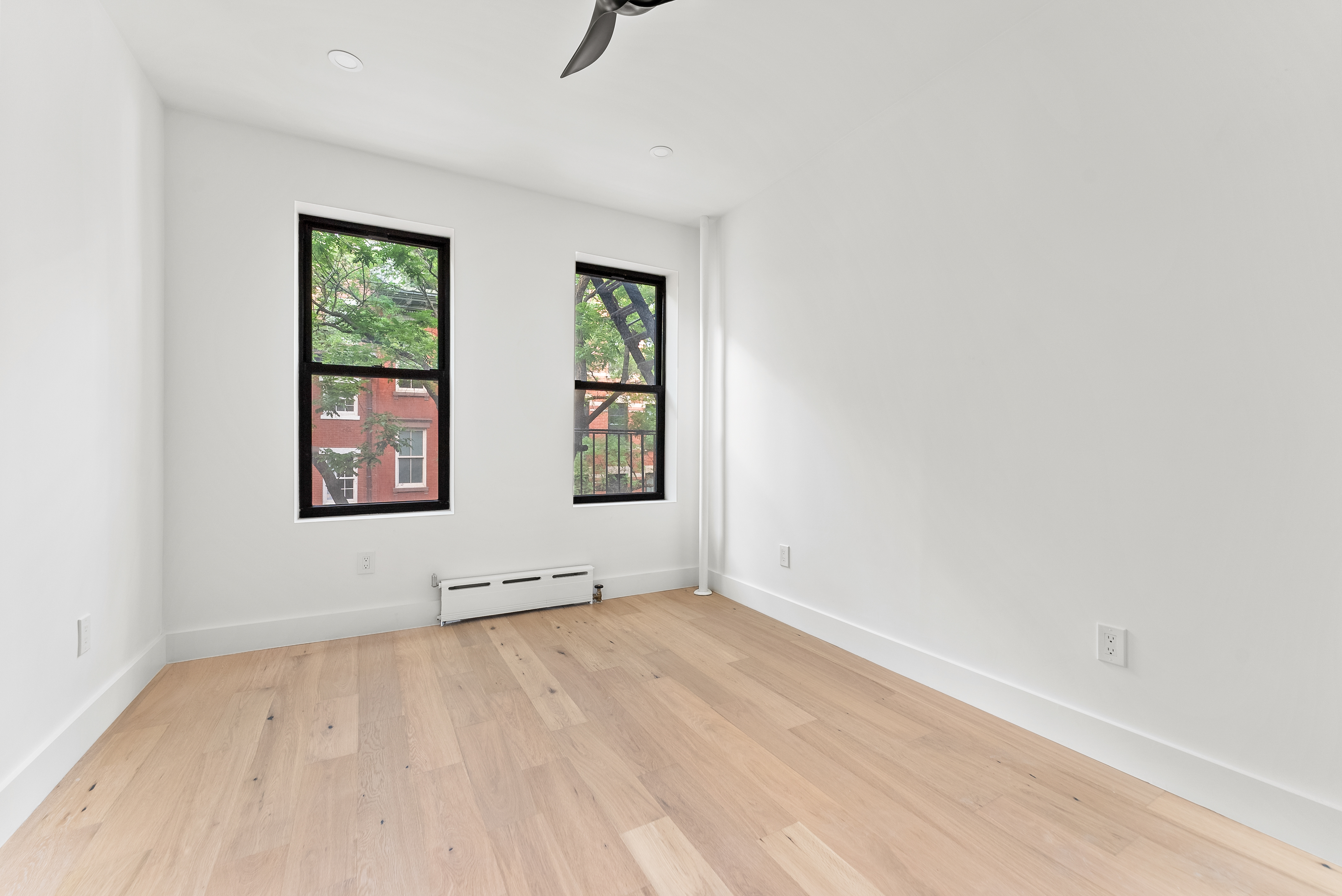 342 West 21st Street, Unit 3E Manhattan, NY 10011 - Photo 7 of 10 an empty room with windows